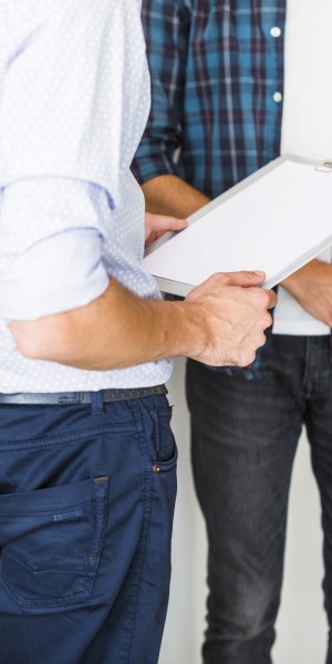 mid-section-view-two-businessman-with-folder-clipboard